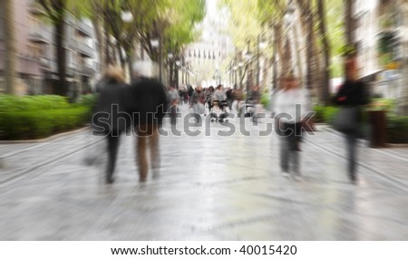 Blurred pedestrian taking a walk in urban background.