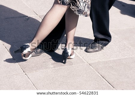 Street dancers performing tango dance. Aged tone. Copy space.