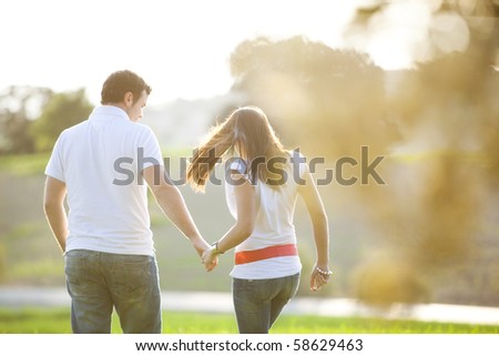 Young anonymous couple taking a walk on nature