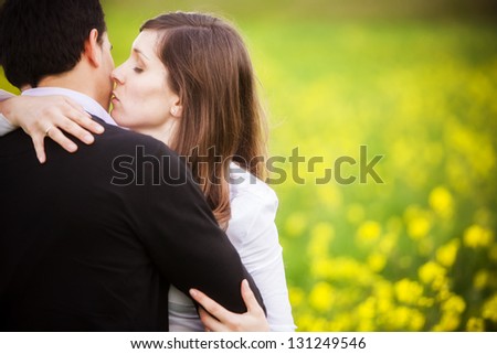 Young couple taking a walk on beautiful flower field.