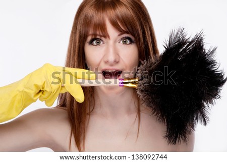 portrait of a cheerful maid with a brush dust