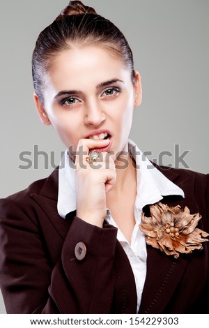 portrait of a girl who bites finger