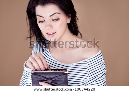woman with open mouth look inside the purse