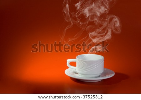 White cup with hot drink on red background