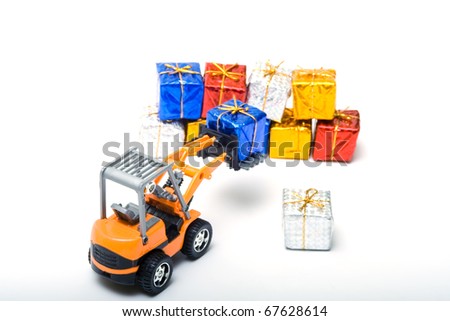 Model toy trucks shifted gifts wrapped in shiny colored paper and tied with gold rope