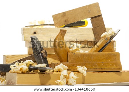 Wooden plane, boards and planed wood shavings on a white background