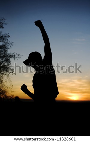 Young man raising his fist in the air for joy.