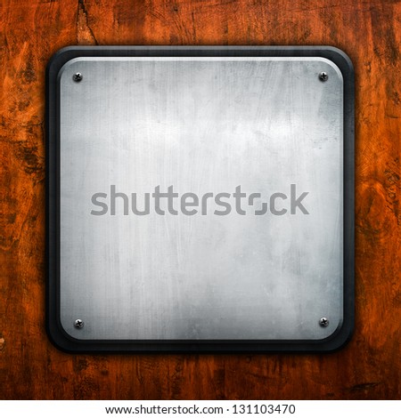 square metal plate on wood background