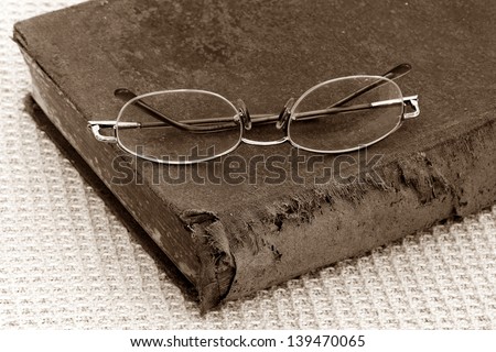old bible and eye glasses,Sepia