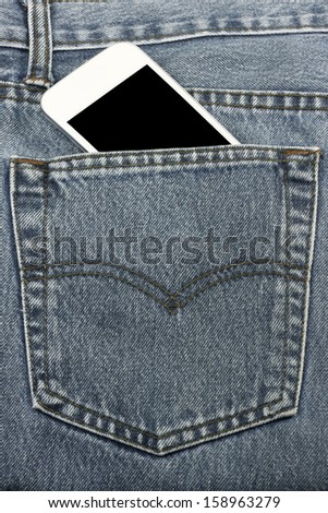 Mobile phone in back pocket jeans. Close-up image