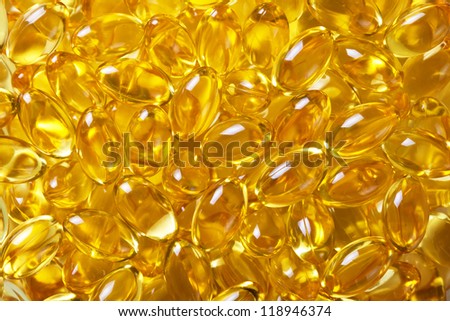 Cod liver oil pills background. Macro shot