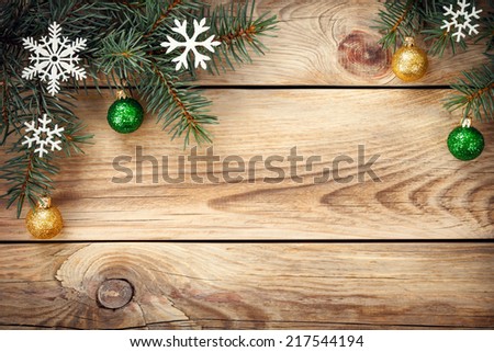 Christmas background with spruce tree, snowflakes and christmas balls on table. Copy space. Top view