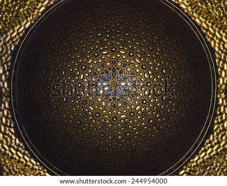 Seville, Spain - January 11, 2015: A detail of golden dome of the ambassadors hall in The Royal Alcazar of Seville. The hemispherical dome rises on scallops with golden stalactite, dated 1427.