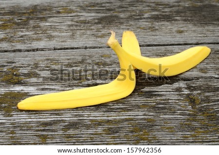 Banana peel on a wooden textured background
