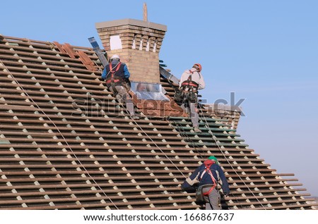 People working on the new roof