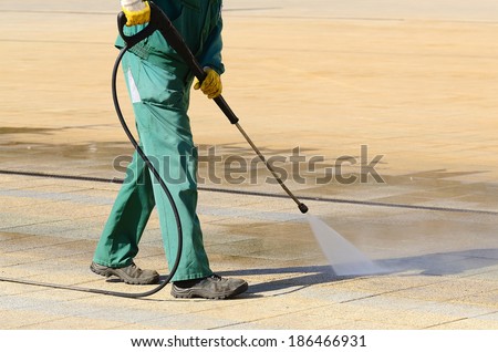 Wet cleaning of city streets with high-pressure cleaner