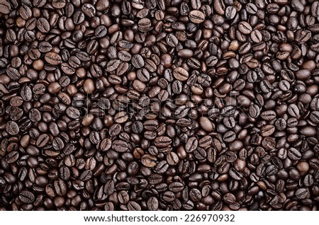 Dark toned photo, lot of coffee beans for background