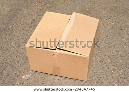 Corrugated cardboard box on asphalt