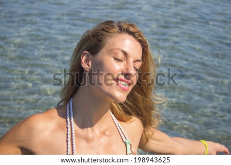 Woman relaxing in the sea water, portrait