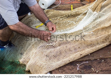 Man weaving fishing net, fishing industry