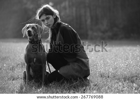 young fashion girl model walk with her dog outdoor park nature background
