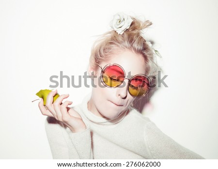 portrait of cheerful blonde hipster girl going crazy making funny face