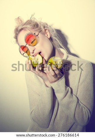 fashion blond woman with green apple holding apple hipster version  bible Eva