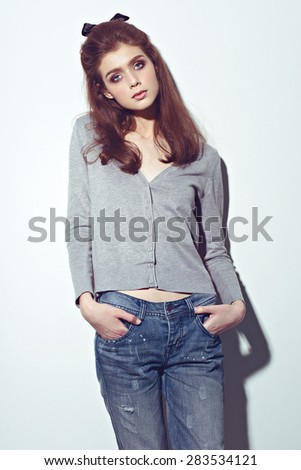 Fashion young woman street style pose on light gray background