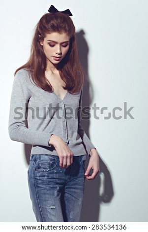 Fashion young woman street style pose on light gray background