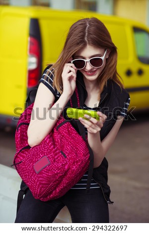 Happy woman using a smart phone in summer in a city.  close up of teenage girl hands with smartphone