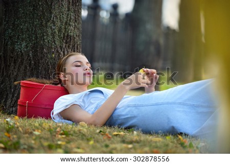 hipster woman in park. jeans fashion city style on a grass in fashionable clothes stockings a sundress