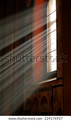 Sunbeams passing through window in Armenian church of Lviv with warm tones