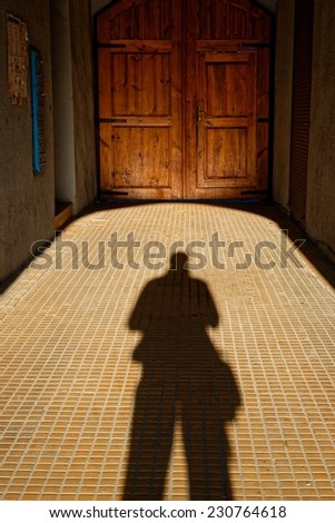 Long person shadow in the corridor with perspective view