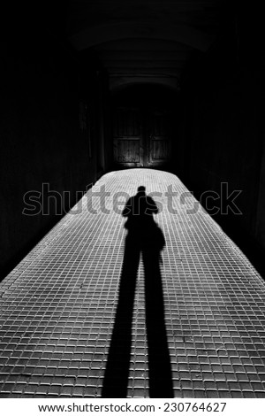Long person shadow in the corridor with perspective view in black and white