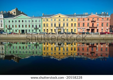 Three multicolor old houses on the river quay
