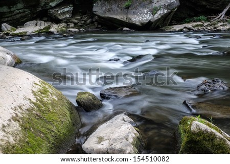 Slippery Rock creek rolling by moss covered rocks.