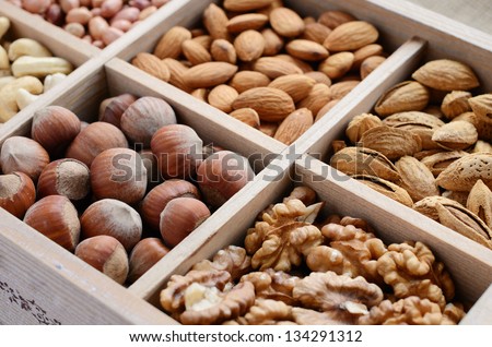 Assorted nuts in wooden box - walnut, almond, hazelnut, cashew and peanuts