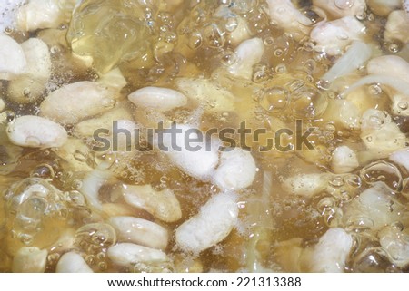 Beans in Boiling Water in a Cook Pot. Food Background.