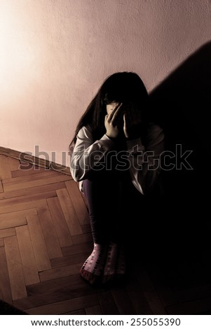 Sad and Lonely Girl Crying with a Hand Covering her Face. Concept: Domestic and Family Violence.