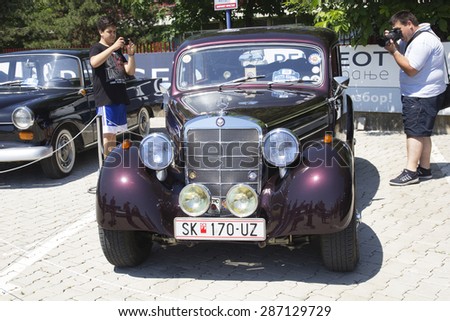 SKOPJE, MACEDONIA - JUNE 13, 2015: Unrecognizable people look around vintage cars on 10th Old Timer Car Show. The event organized by Euroimpex from Skopje.