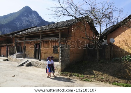 HAGIANG, VIETNAM, FEBRUARY 17: Two ethnic minority girl are in front of a ancient house on February 17, 2013 in Hagiang, Vietnam. Hagiang is a northernmost province in Vietnam