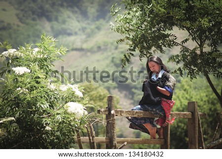MUCANGCHAI, VIETNAM - MAY 27: Unidentified Hmong Ethnic Minority woman are sewing on May 27, 2011 in Mucangchai, Vietnam. H\'mong are the 8th largest ethnic group in Vietnam.