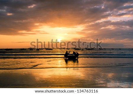 Fishermans are working in sunrise at My Khe beach, Danang, Vietnam