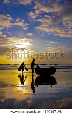 Fishers work on the beach in sunrise in My Khe beach, Da nang, Vietnam
