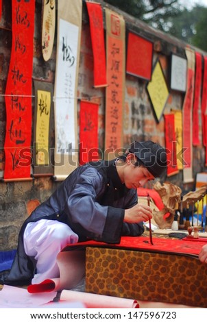 HANOI, VIETNAM, FEBRUARY 14: A master is writing ancient letter for everyone in lunar new year on February 14, 2013 in Hanoi, Vietnam. This is a tradition of vietnamese people in lunar new year