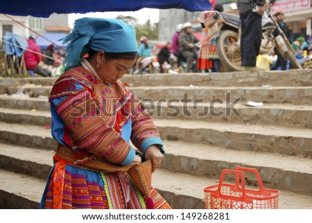LAOCAI, VIETNAM, FEBRUARY 10: Unidentified ethnic minority woman in a traditional market on February 10, 2012 in Laocai, Vietnam. There are many ethnic minority groups in Laocai