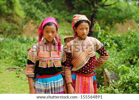 LAOCAI, VIETNAM, SEPTEMBER 2: Two unidentified ethnic minority girls on the way to traditional market on September 2, 2010 in Laocai, Vietnam. There are many ethnic minority groups in Laocai