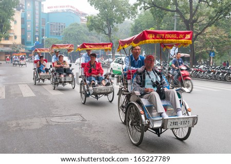 Hanoi, Vietnam, November 28: Cyclos Drivers Carry Tourists On November 28, 2013 In Hanoi, Vietnam. Cyclo Used To Be A Popular Transportation In Vietnam, It Is For Tourism Now