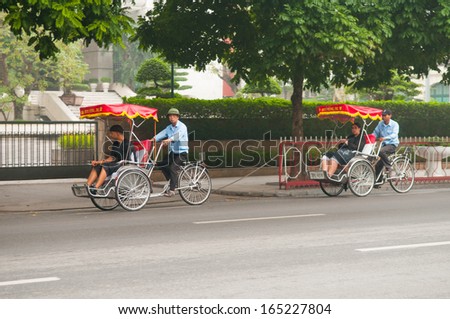 HANOI, VIETNAM, NOVEMBER 28: Cyclos drivers carry tourists on November 28, 2013 in Hanoi, Vietnam. Cyclo used to be a popular transportation in Vietnam, it is for tourism now