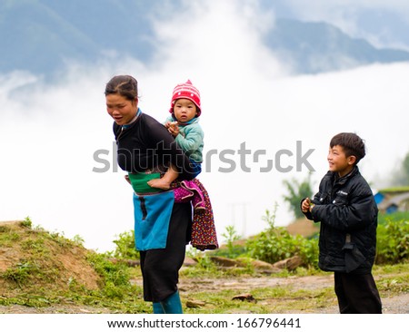 LAOCAI, VIETNAM, MAY 30: An ethnic woman with her children near her house on May 30, 2013 in Laocai, Vietnam. There are many ethnic minority groups in Laocai